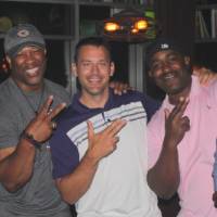 5 men throw peace signs